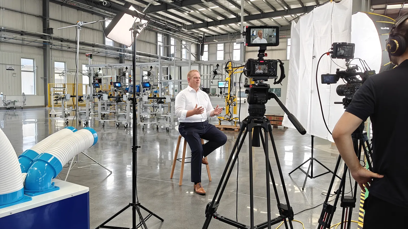 Video crew filming an industrial interview in China
