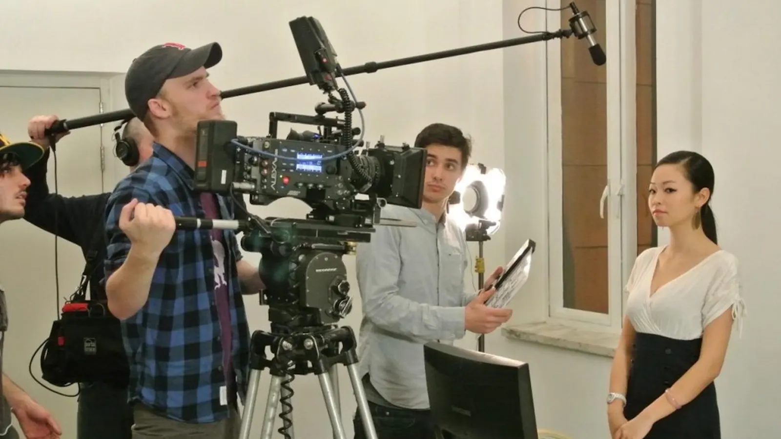 Professional camera crew filming a corporate interview in China